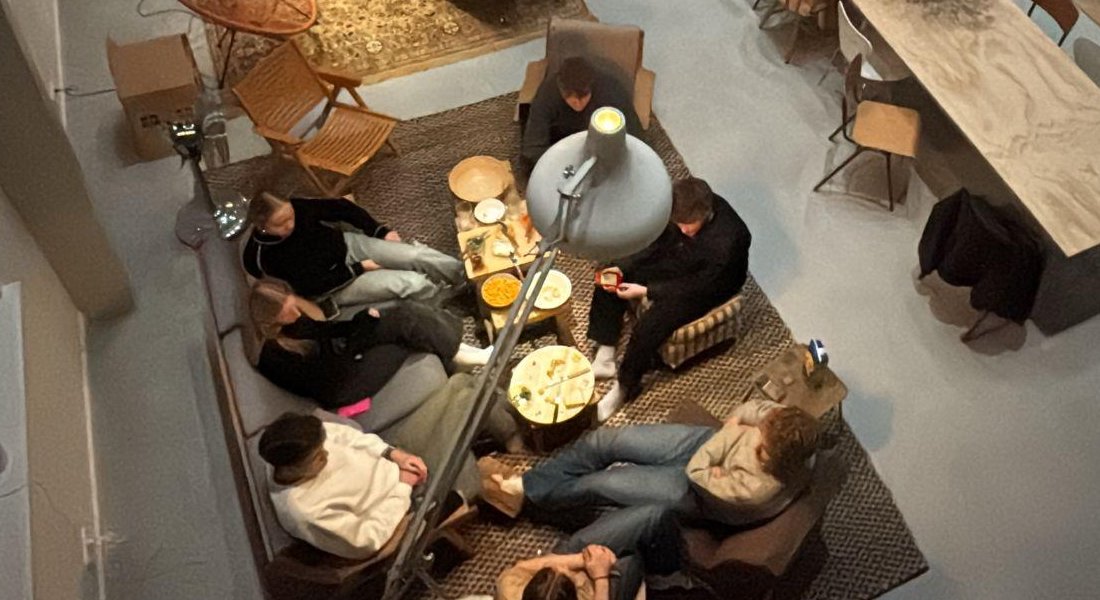 A group of people gathered around a table at Helium House: a relaxed event setting